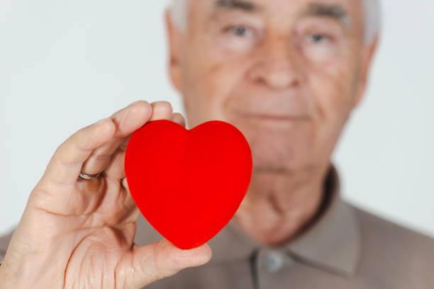 istock Senior Man Holding a Heart Symbol 2181908308