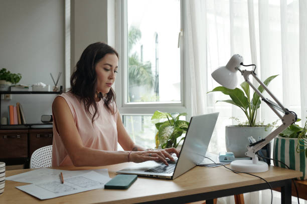 istock Woman Working at Desk with Laptop in Home Office 2181908536