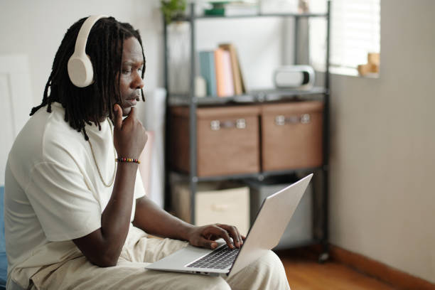 istock Young Man Engaging in Work with Headphones On 2181909145