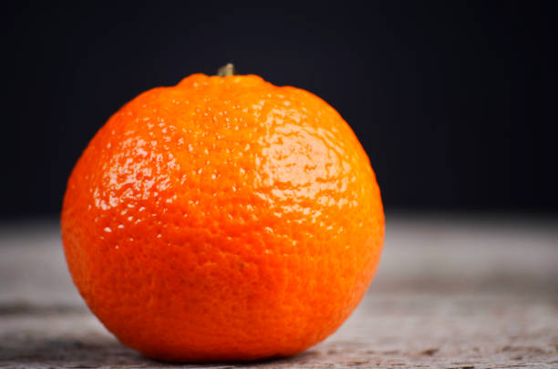 istock Fresh juicy tangerine on black background 2181909219