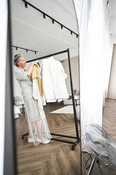 istock Clothing store owner reflection in a mirror. 2181911845