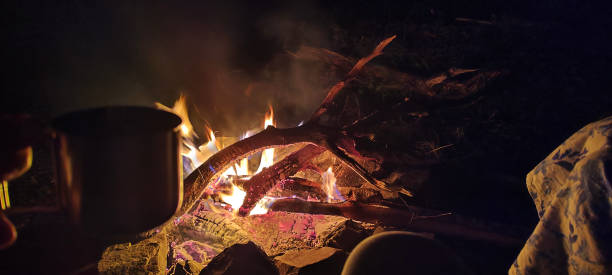 istock Unregognisable people sitting by a campfire 2181913100