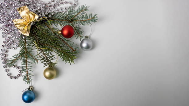 istock Christmas tree branches with small balls beads and a golden bow 2181915289