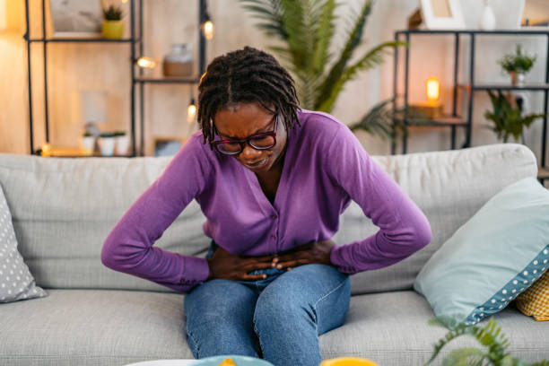 istock Young Woman Having A Stomachache At Home 2181916413