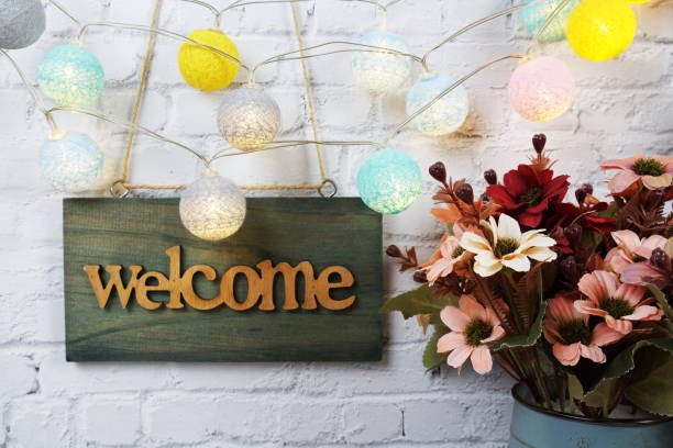istock Welcome sign Hanging on grunge cement wall background 2181921738