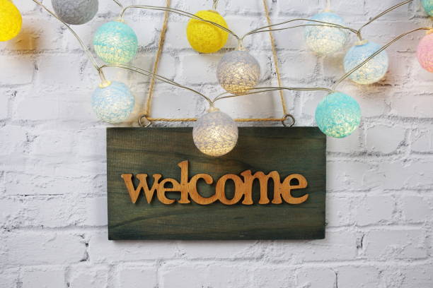 istock Welcome sign Hanging on grunge cement wall background 2181921749