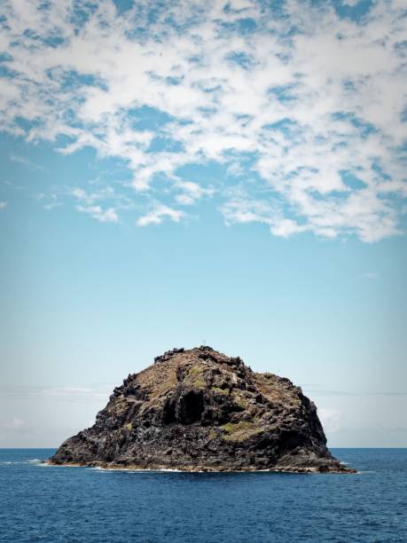 istock Solitary Rocky Island Under Blue Sky 2181922564