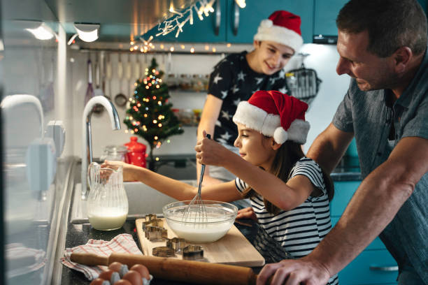 istock Father assists daughter in joyful holiday batter mixing 2181928636