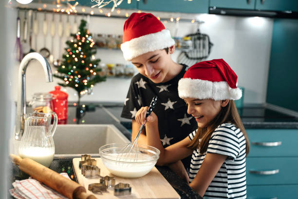 Siblings whisk batter in holiday-themed decorated kitchen