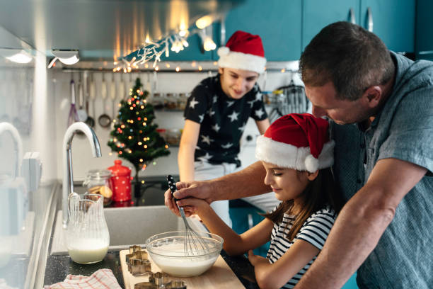istock Guided whisking by father and daughter in Christmas kitchen 2181928658