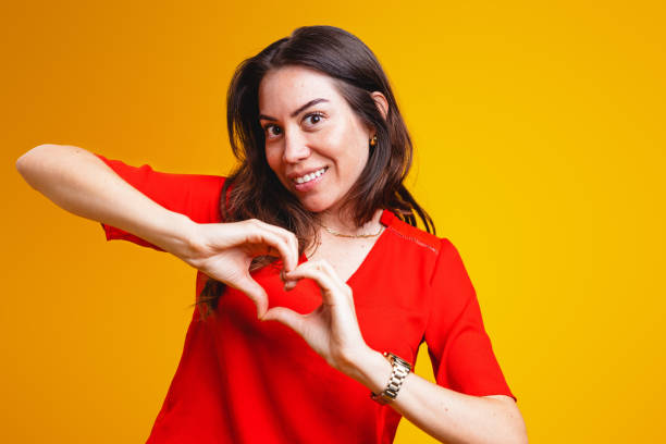 istock Hispanic Woman Making Heart Gesture Portrait 2181929403