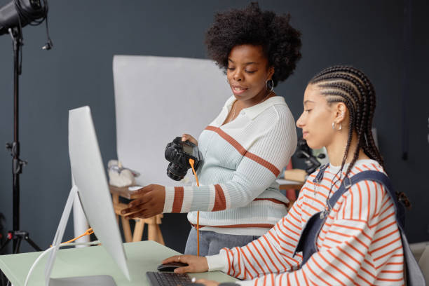 Female Photographers Collaborating in Photo Studio