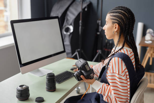 istock Black Young Woman As Female Photographer using Computer 2181930328