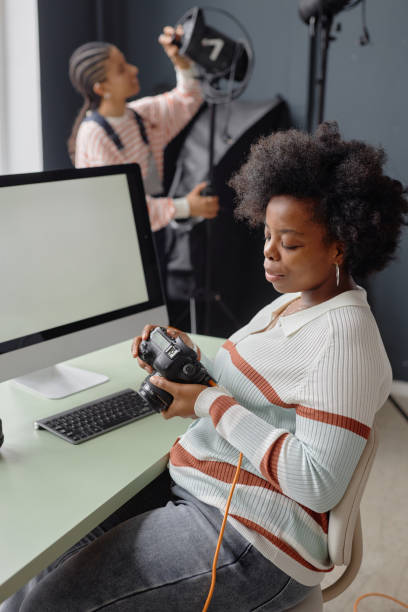 istock Photographer Looking At Pictures on Camera Screen 2181930677