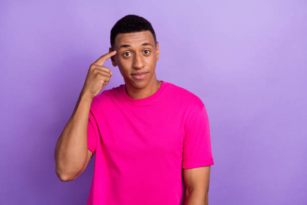 istock Photo of smart happy minded guy point temple finger idea genius solution empty space decision advertisement isolated on violet color background 2181930848