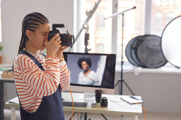 istock Female Photographer Taking Photos in Studio 2181930956