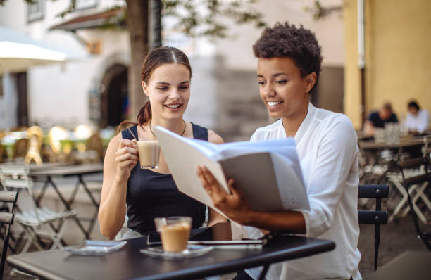 istock Diverse Female Students Studying at Outdoor Cafe 2181934680