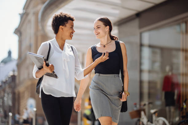 istock Diverse Female Students Engaging with Technology on Urban Street 2181934717