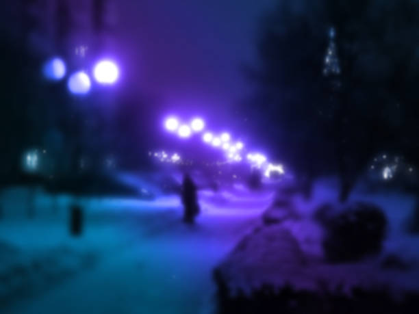 istock A blurred image of an evening winter alley as background. 2181935467