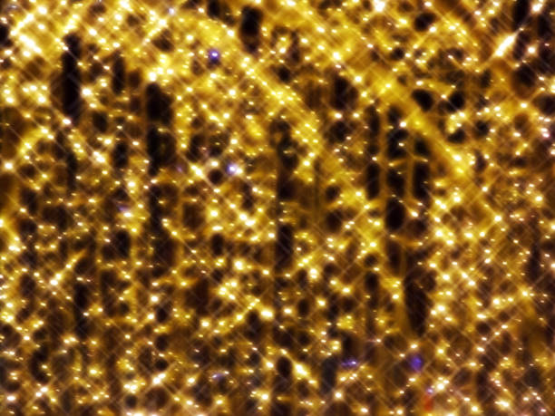 istock Blurred background of festive yellow lights on a dark background. 2181935538
