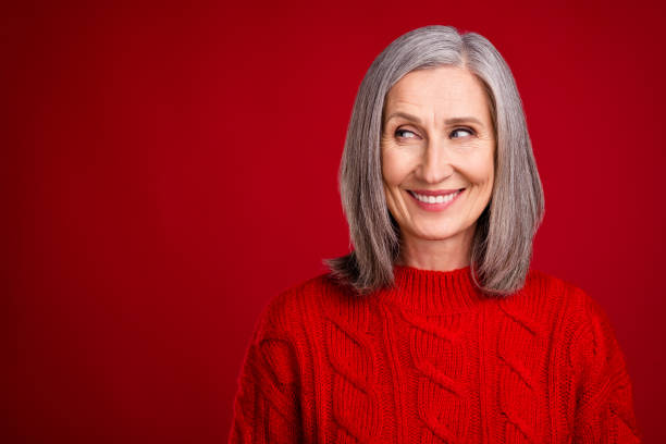 istock Photo of dreamy inspired thoughtful grandmother look empty space wear knitted pullover isolated red color background 2181937607