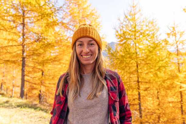 istock Smiling Woman Enjoying Autumn in Forest 2181938773