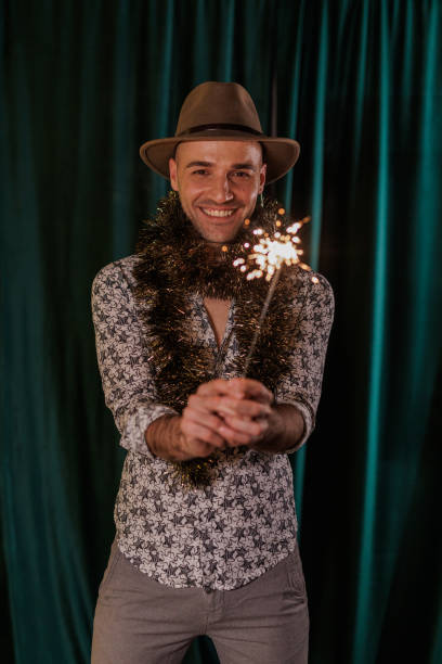 istock Joyful man celebrating with sparkler 2181940458