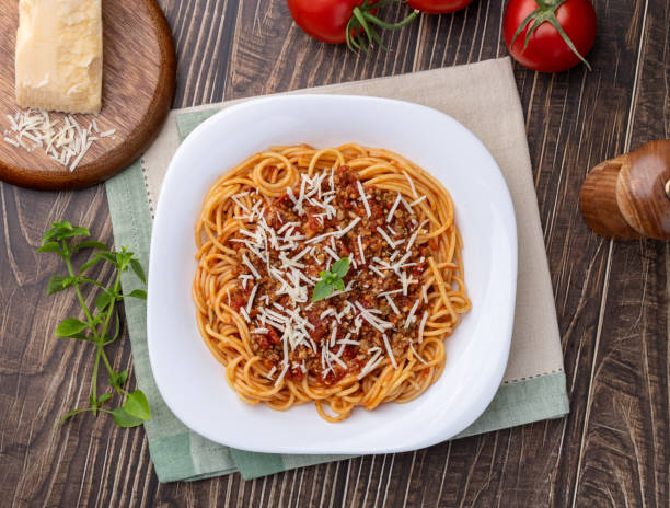 istock Spaghetti pasta on a plate with bolognese sauce, basil and parmesan cheese 2181941211