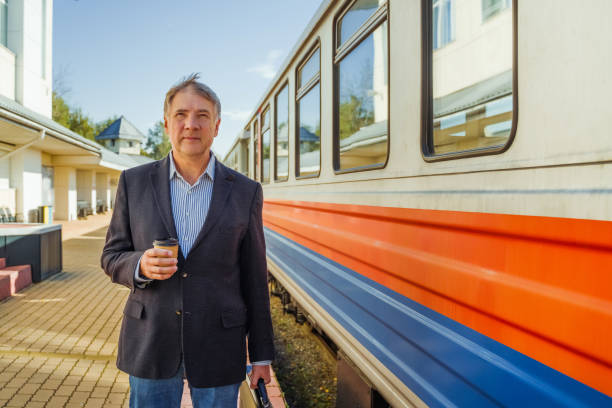 istock A mature businessman stands on the platform waiting to board a train 2181941673