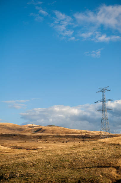 istock Powerline towers stand tall against a blue sky, symbolizing energy infrastructure 2181942480