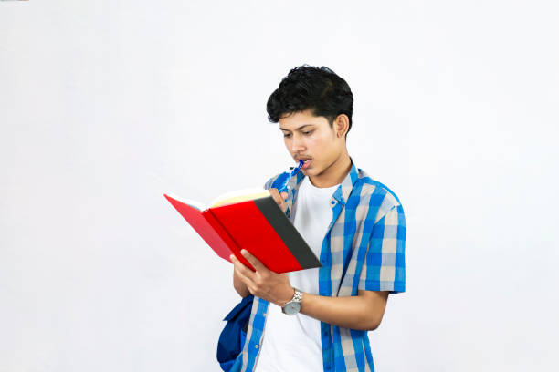 Young Male Study Abroad Concept with Bag, Books and headphone gives expression and gestures Student
