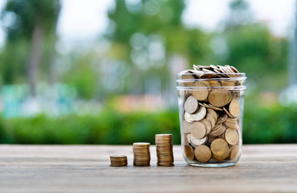 istock Coin stairs and jar on wooden table 2181944313