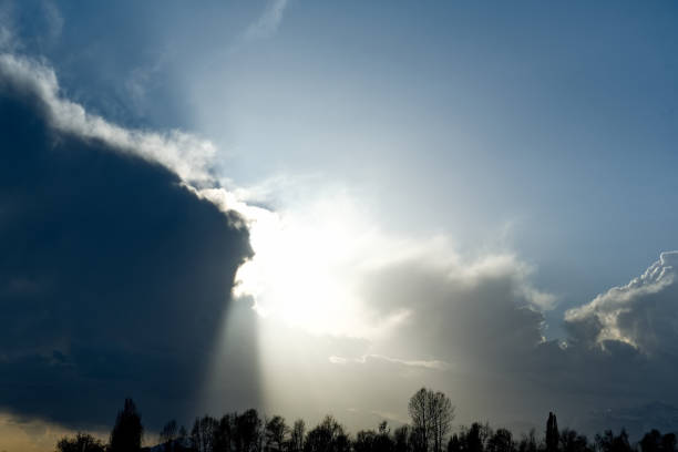 Kyrgyzstan, Karakol. A gloomy view of the setting sun behind heavy storm clouds on the shore of Lake Issyk-Kul.