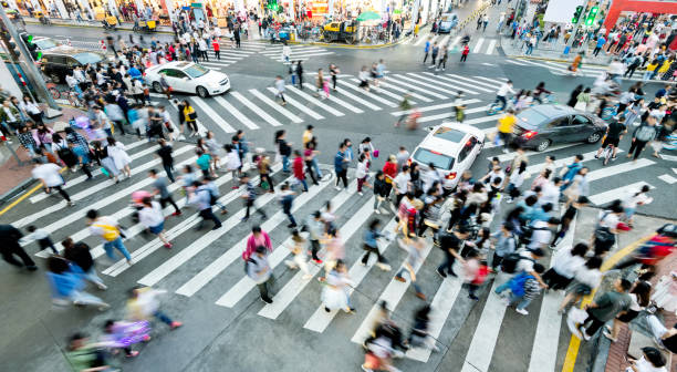 istock Motion blurred people and cars on the sidewalk 2181944478