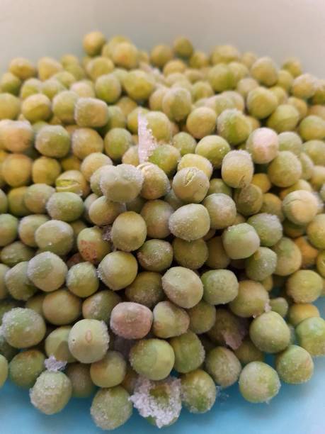 Frozen green peas in bowl