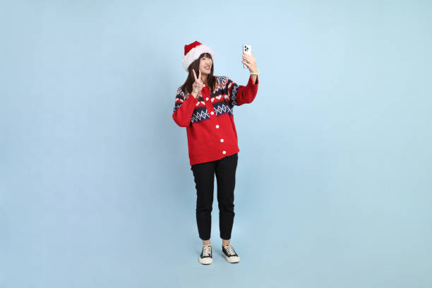 istock Woman wearing Santa hat 2181947998