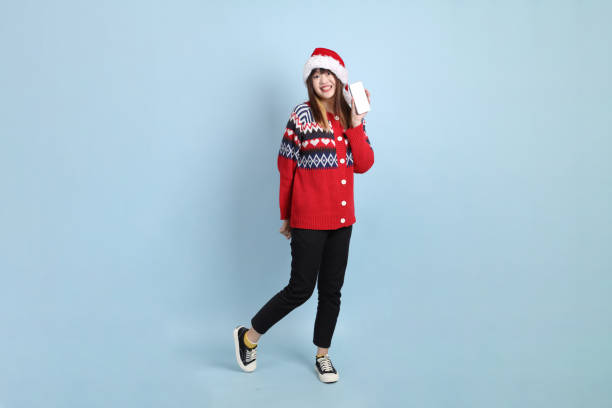 istock Woman wearing Santa hat 2181948035