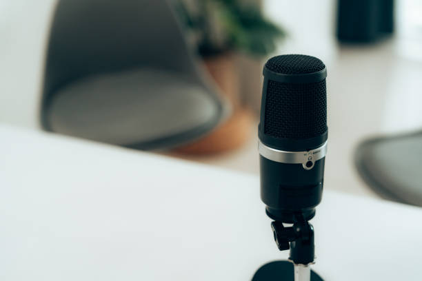 istock Close-up of a high-quality microphone in a contemporary, empty podcast studio with blurred background. Perfect for podcasting, broadcasting, or audio recording themes. 2181950524
