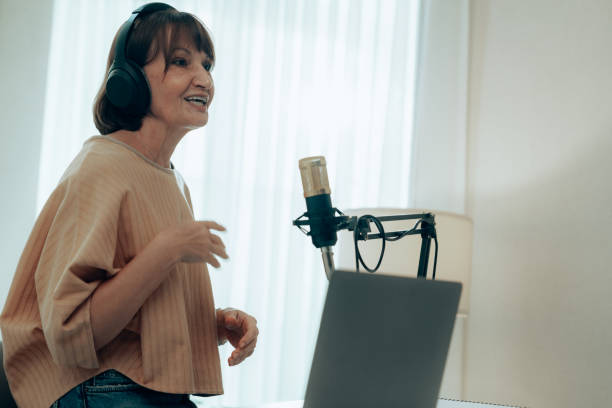 istock Authentic Podcast Session with Mature Female Host in Home Studio with Quality Audio Equipment 2181950597