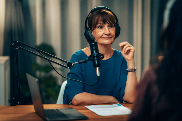 istock Engaging Podcast Host: Mature Woman Conducting Interview in Professional Studio 2181950644