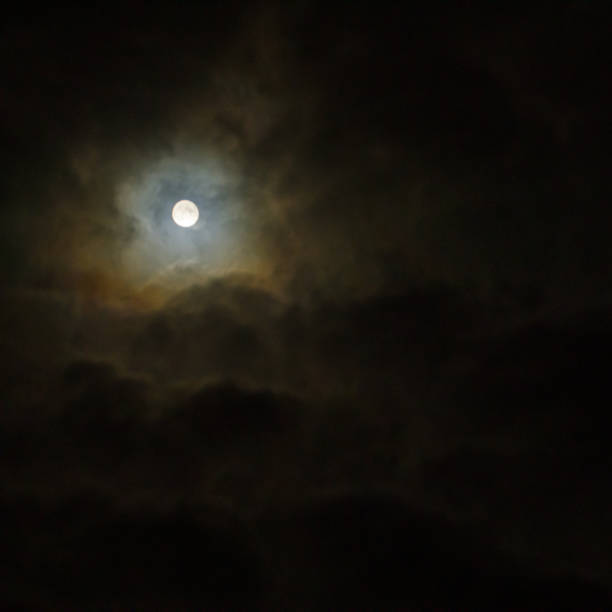 istock Full moon in the dark night sky with clouds. 2181951915