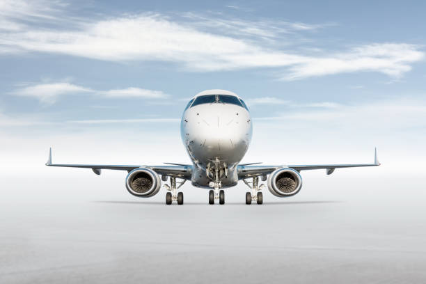 istock Front view of white passenger airplane isolated on bright background with sky 2181952248