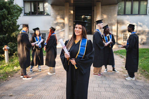 istock Graduation celebration outdoors as students proudly hold their diplomas on a sunny day, showcasing joy and accomplishments at the university campus 2181952908