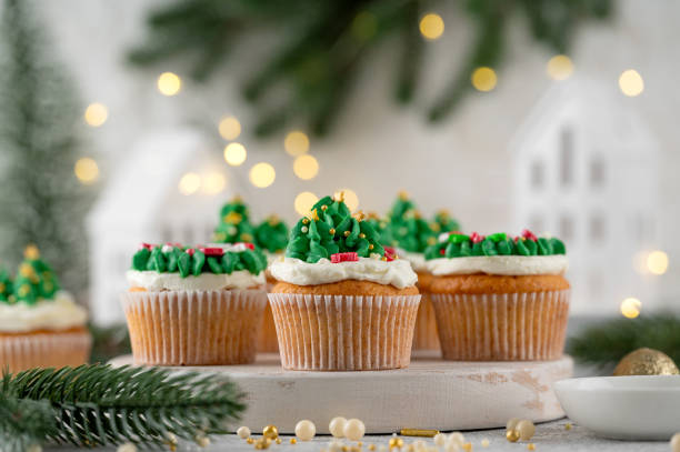 istock Christmas tree and wreath shaped cupcakes with candy sprinkles on top. Christmas dessert on a light concrete background. 2181956820