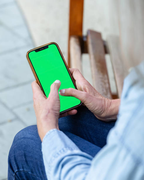 istock Woman holding phone with a green screen 2181958170