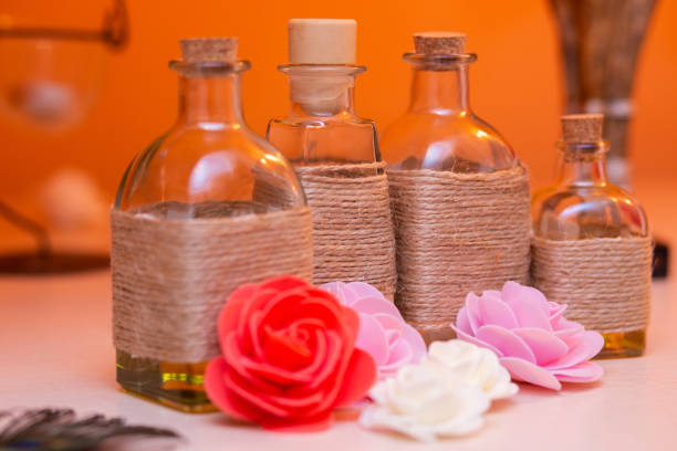 istock beautiful bottles with massage oil on orange background 2181963064
