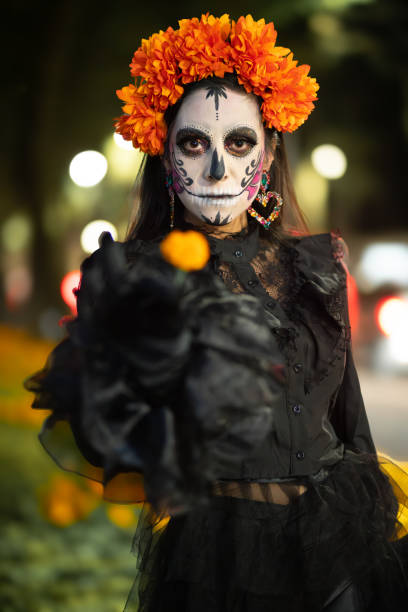 istock Catrina Holding a Single Marigold in Vertical Portrait 2181963440