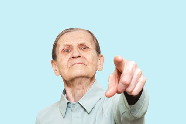 Two carefree elderly men with arms outstretched at park