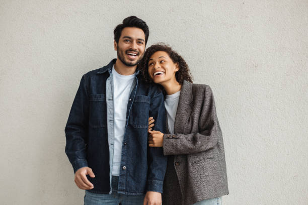 istock Happy multiracial couple smiling and embracing on white background 2181966305