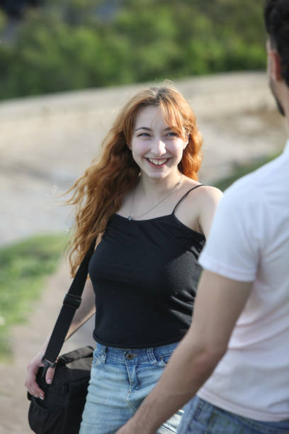 istock young cheerful loving couple walking outside 2181966857